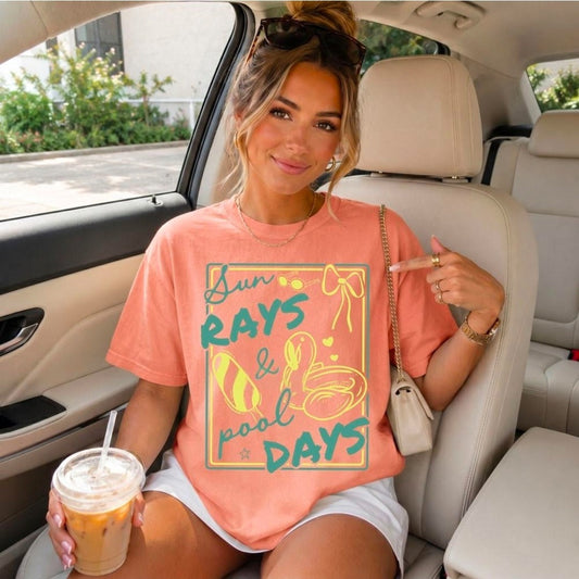 Woman wearing coral Sun Rays & Pool Days oversized Comfort Colors graphic tee